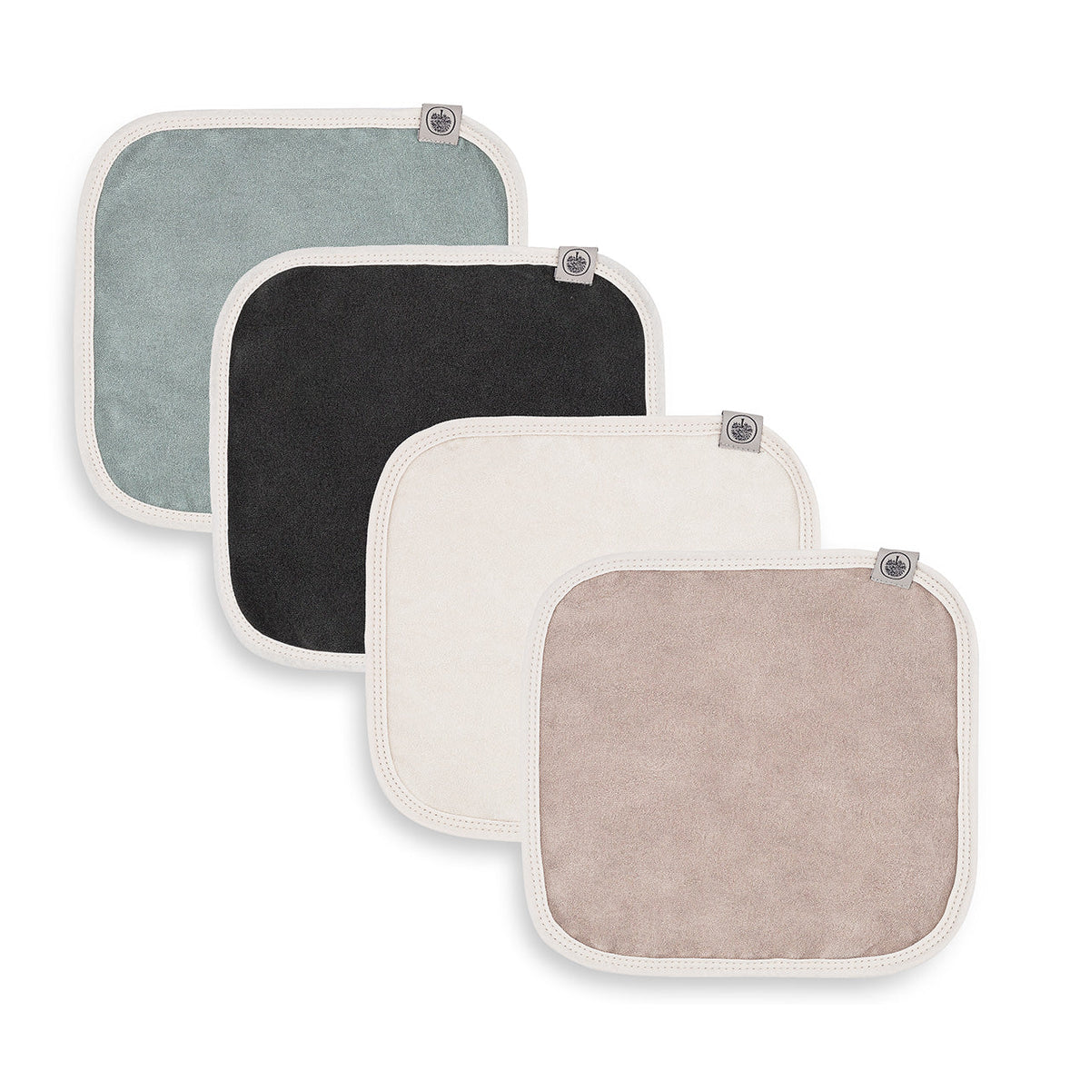 Four terry washcloths laid out in a staggered arrangement on a white background.