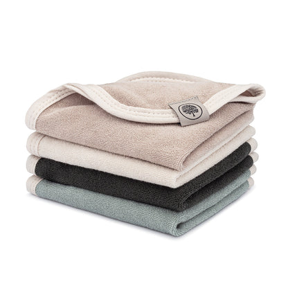 Four folded terry washcloths in neutral colors, stacked on a white background.