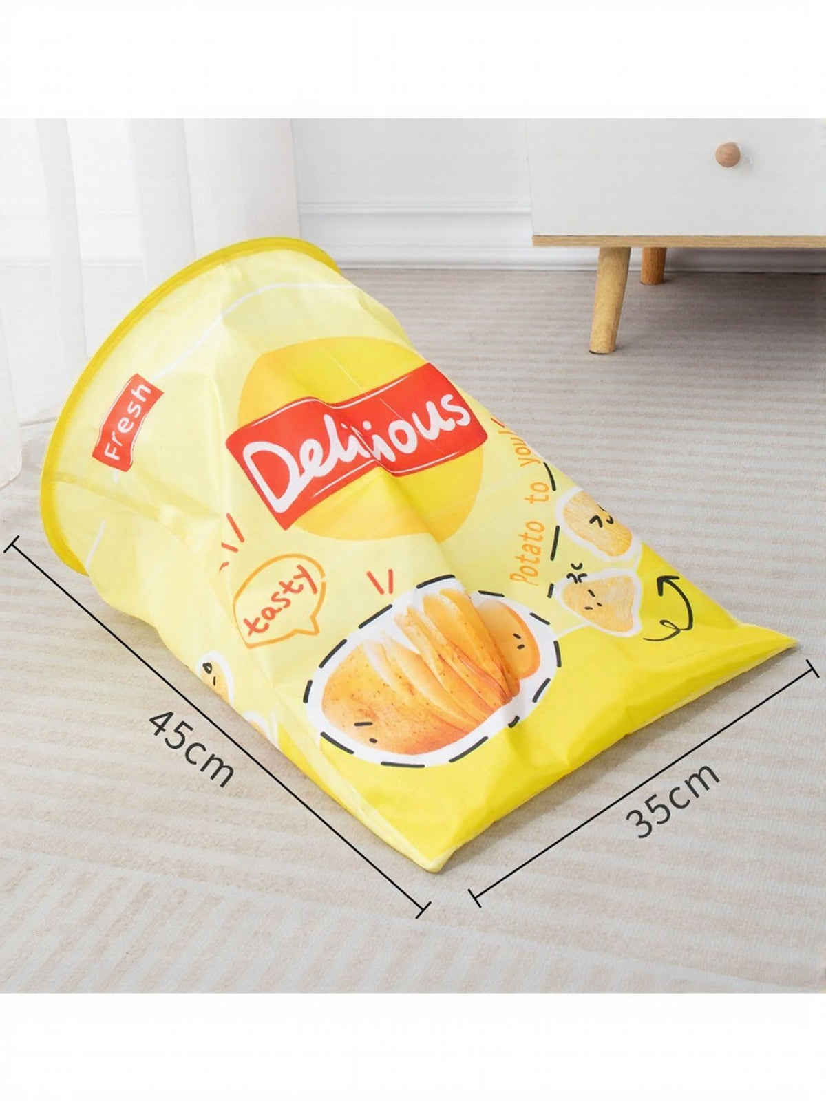Yellow snack-package-print cat tunnel with 45 by 35 centimeter dimensions.