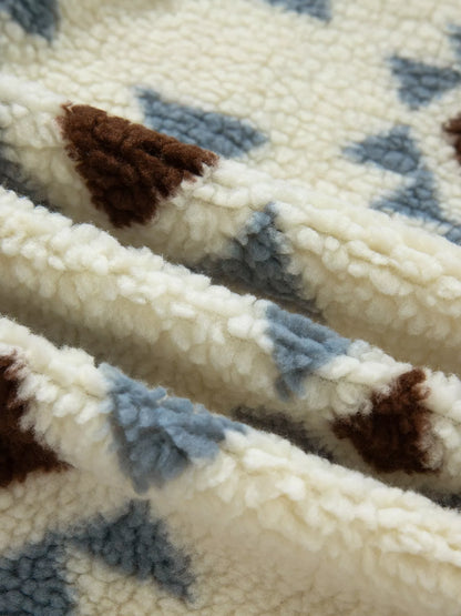 Close-up of the beige, blue and brown sherpa-textured sweatshirt fabric.