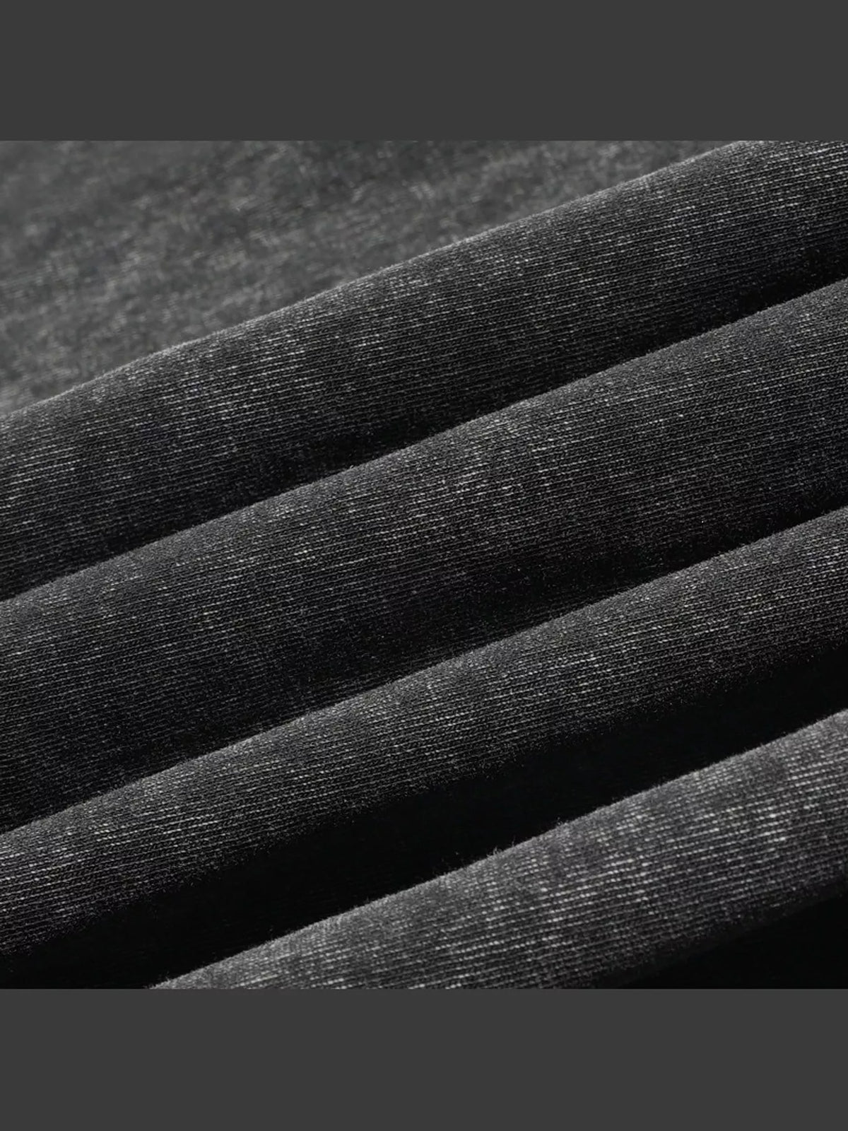 Close-up of the black shirt fabric and seam.