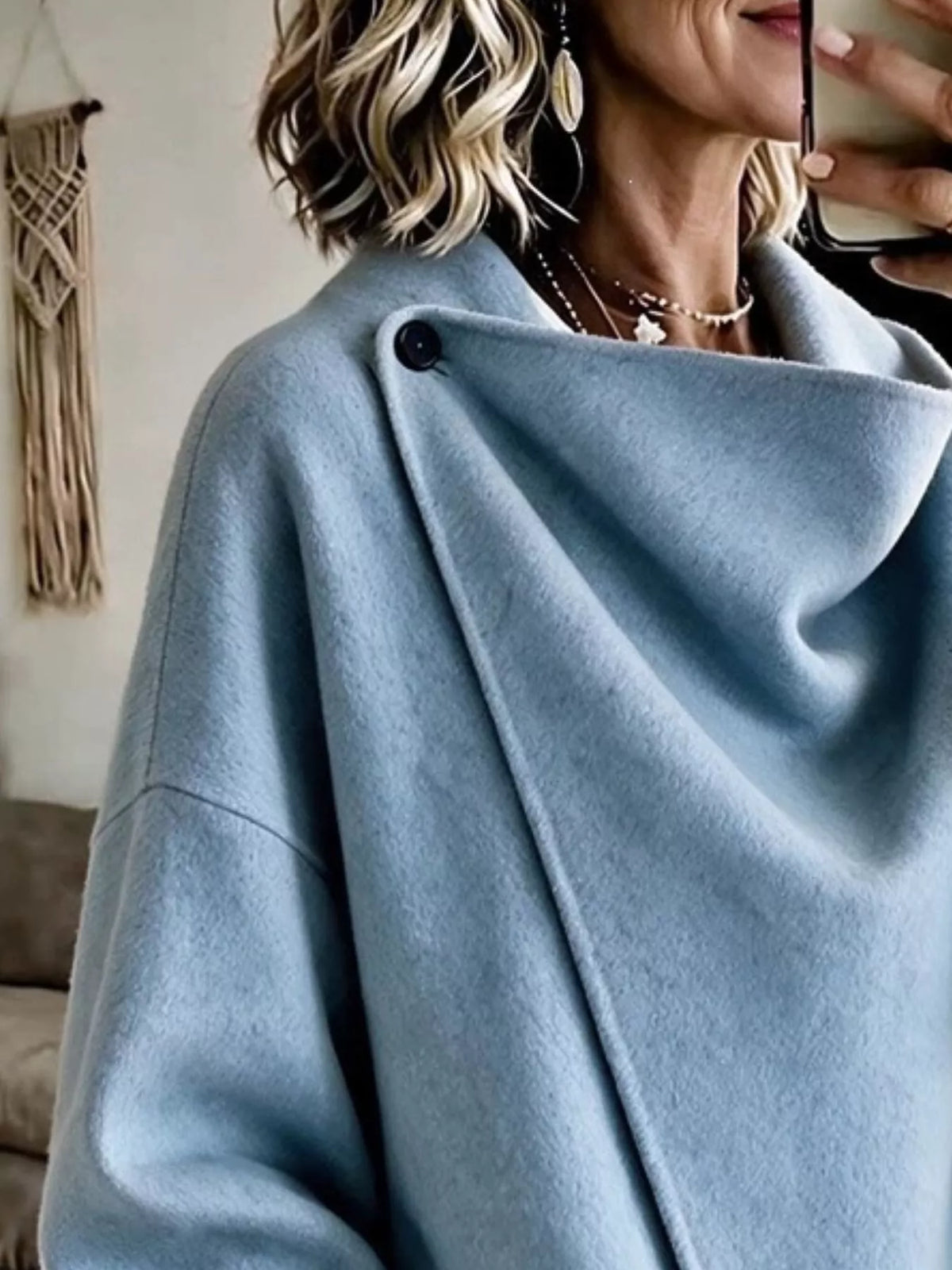 Sky Blue asymmetric cowl-neck cape, close-up of the draped neckline and button detail