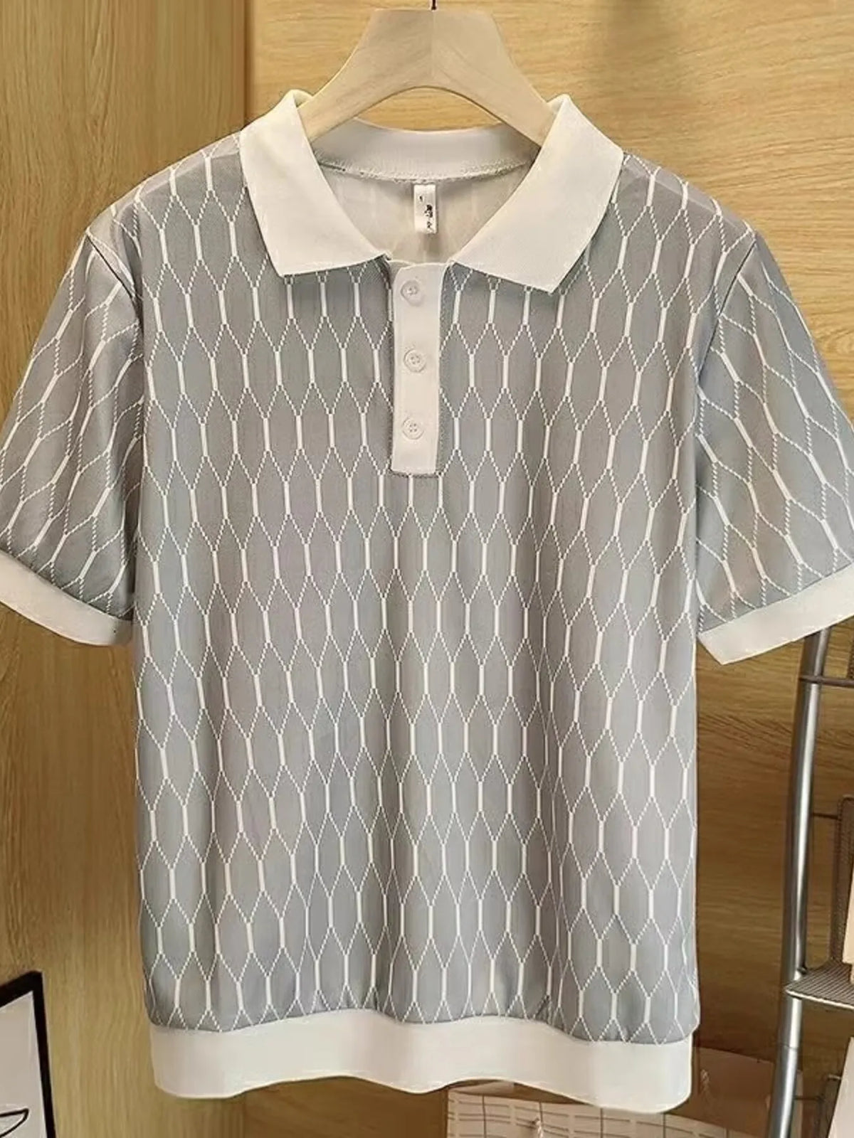 Grey diamond-pattern polo with a light contrast collar, button placket and ribbed trim; hanger not included.