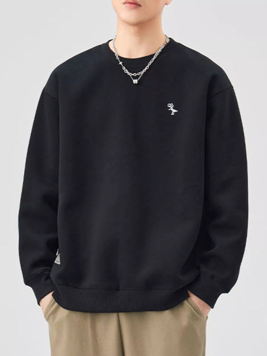 Men's black round-neck sweatshirt with small chest motif, front view