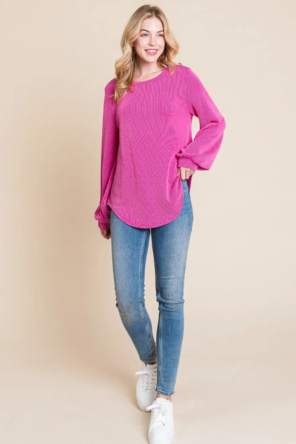 Full-length styling view of the fuchsia ribbed top; jeans and footwear not included