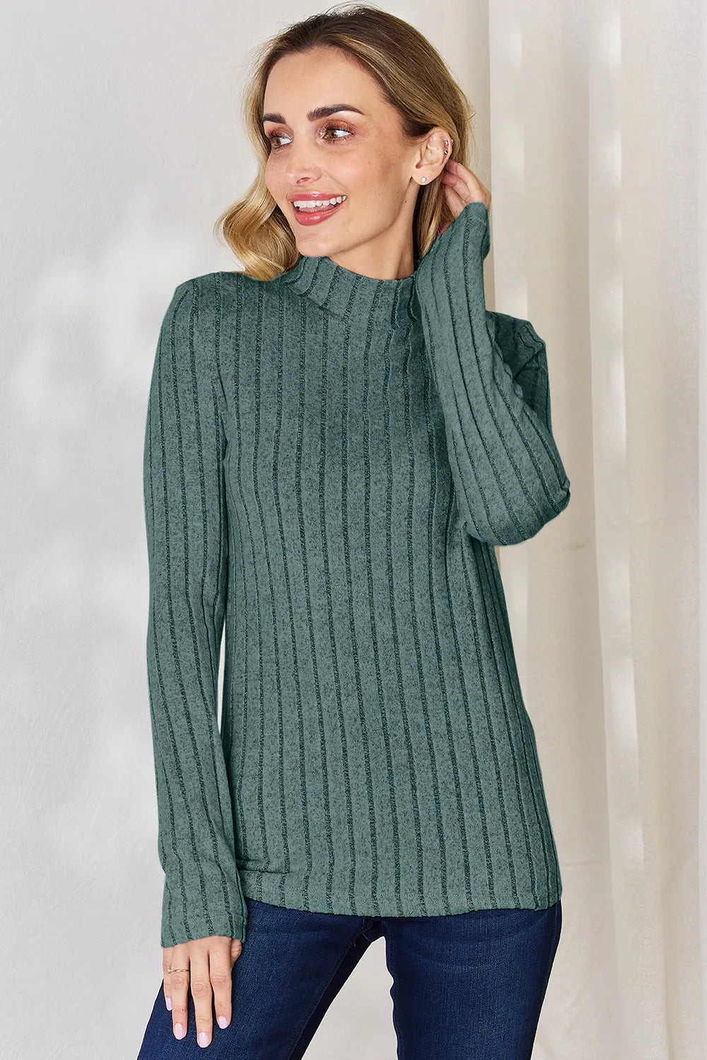 Turquoise ribbed mock-neck long-sleeve top, product view; one top included, jeans and accessories excluded