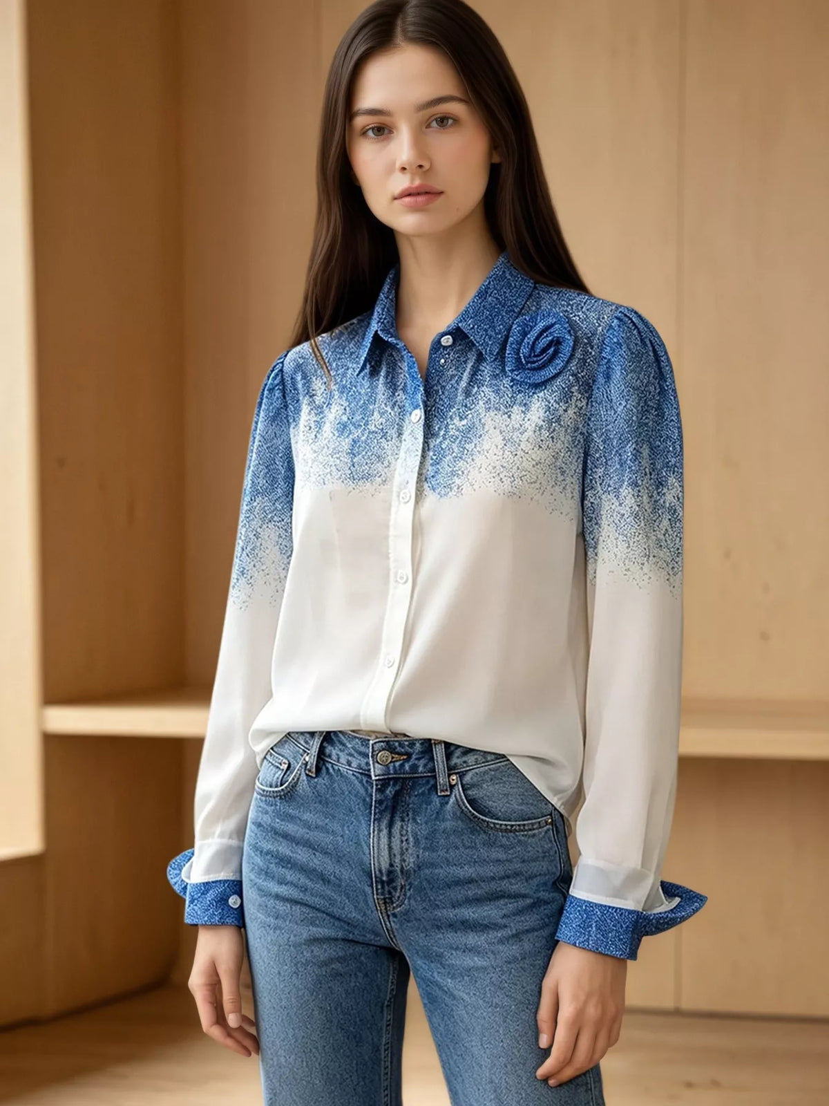 Blue-to-white gradient button-up shirt with floral detail and long sleeves, front view on a model
