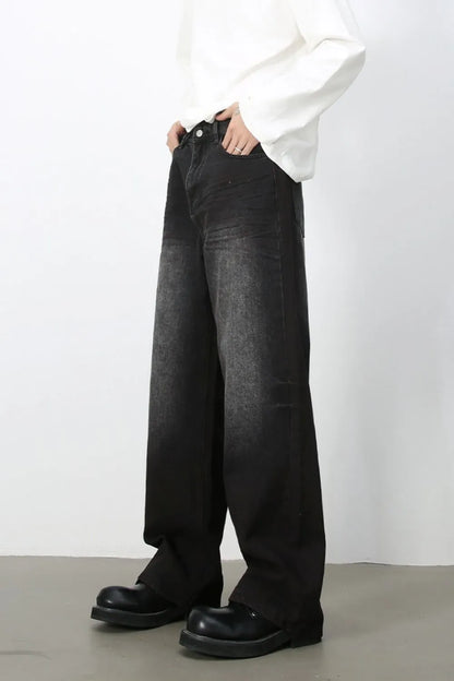 Angled view of men's dark-wash loose-fit wide-leg jeans.