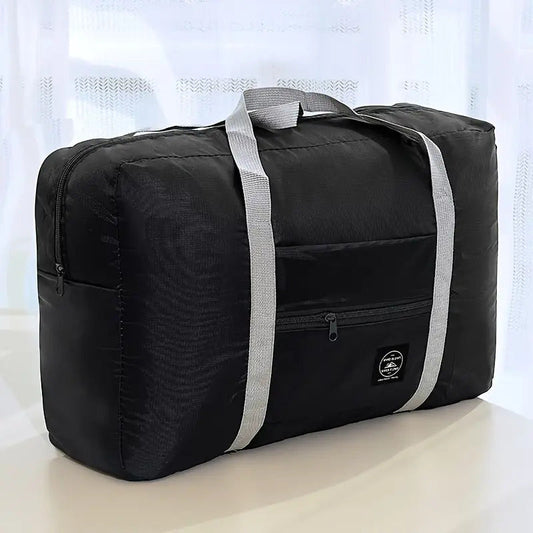 Black foldable travel duffel bag with gray handles and a front zip pocket.
