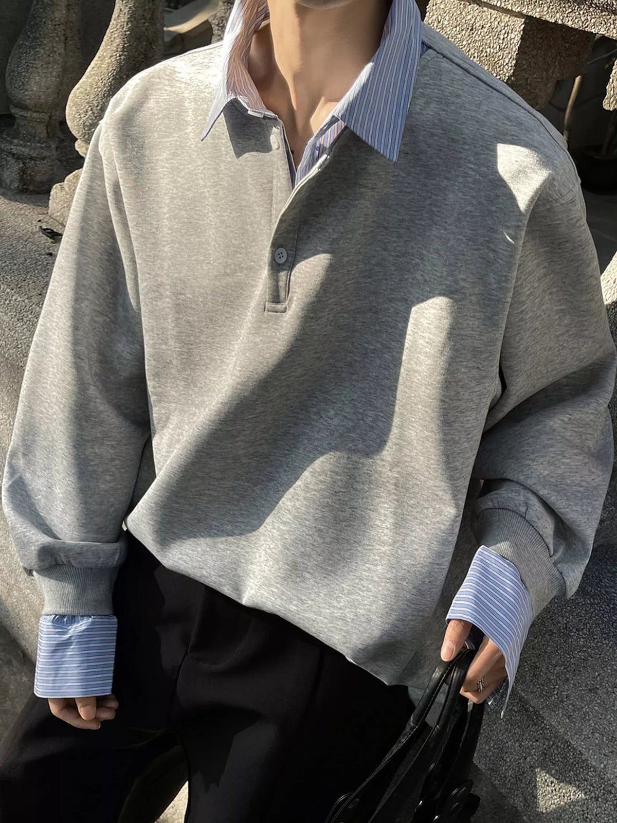 Gray layered-look sweatshirt with striped collar and cuffs, front detail