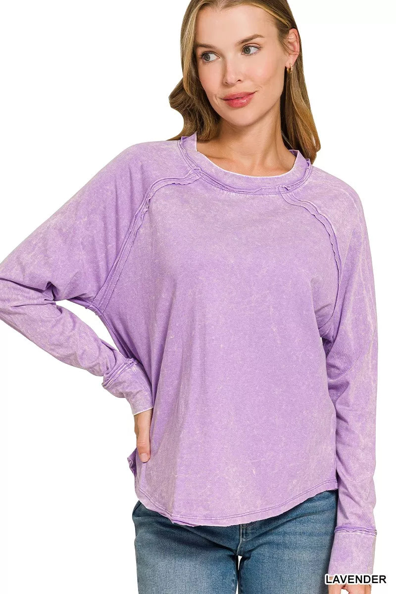 Lavender Zenana washed crewneck top with long sleeves and exposed seams, front view on a model. Top only; styling accessories excluded.