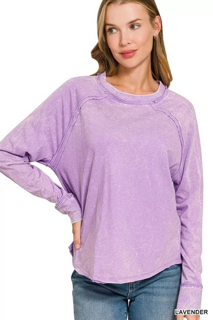 Lavender Zenana washed crewneck top with long sleeves and exposed seams, front view on a model. Top only; styling accessories excluded.