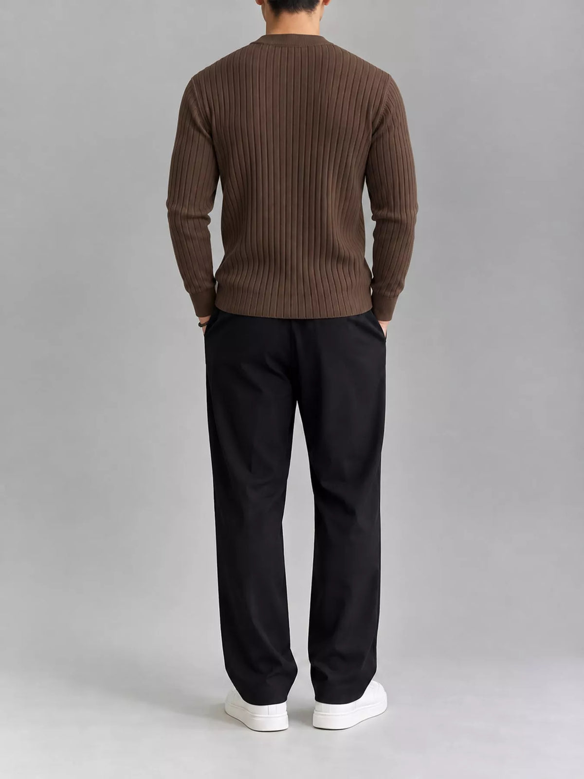 Coffee-colour ribbed knit top, modelled rear view. Trousers and shoes are not included.