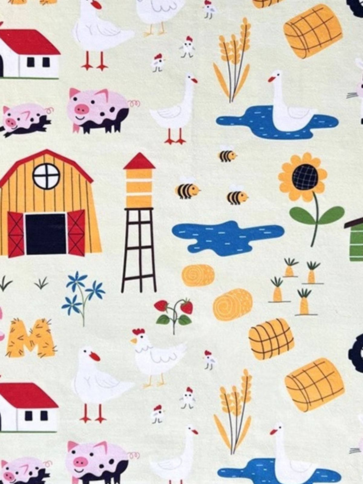 Close-up of the Animal Farm pet towel print with barns, pigs, cows and tractors.