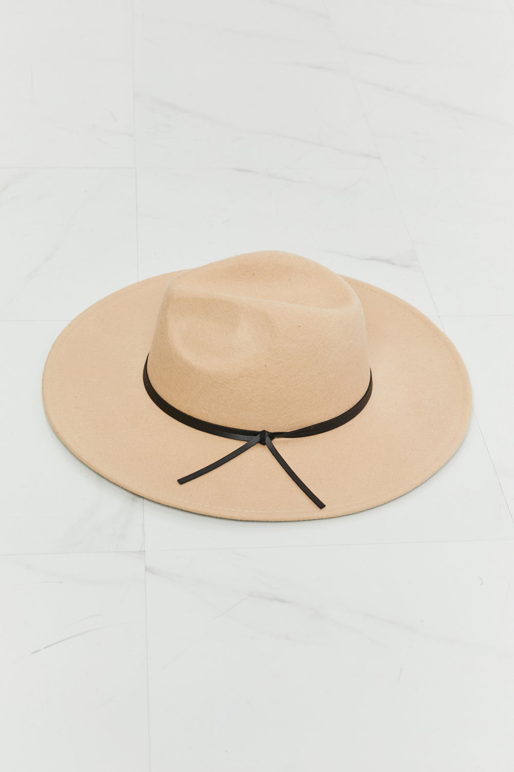 Beige Fame fedora hat with a black knotted faux-leather band, front view