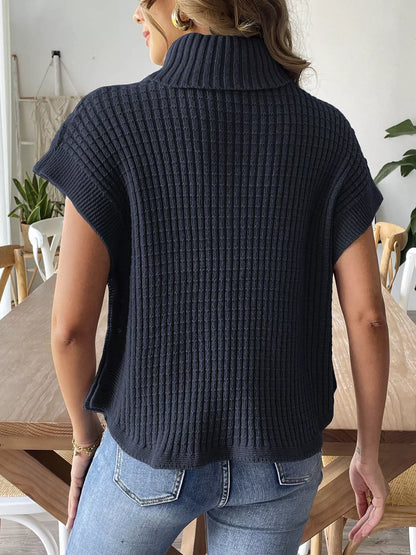 Back view of the Navy Blue ribbed turtleneck sweater vest; jeans are styling only.