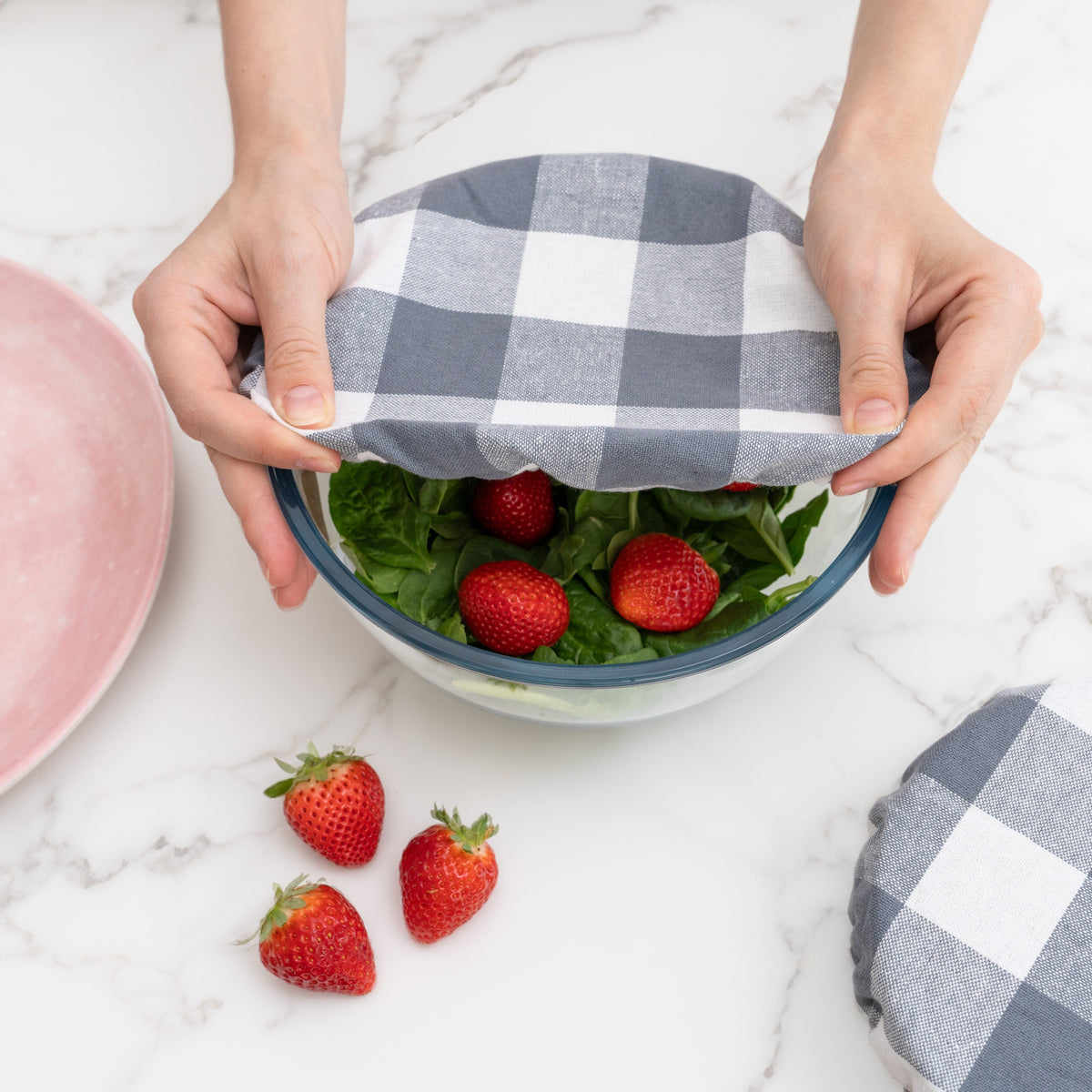 Gray and white checked cover stretched over a berry bowl