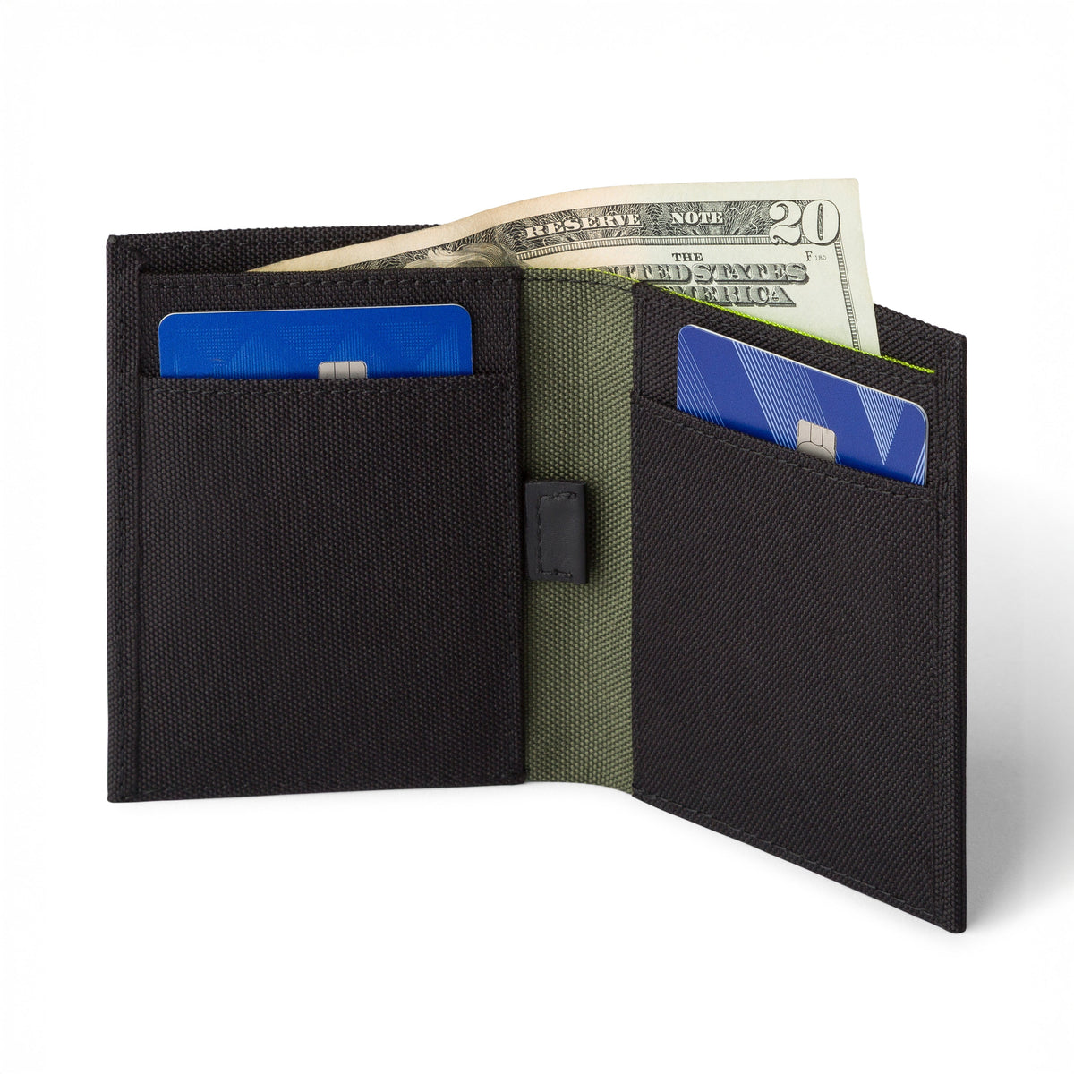 Black COR Surf bifold wallet open, showing card pockets and cash sleeve; cash and cards are display props.