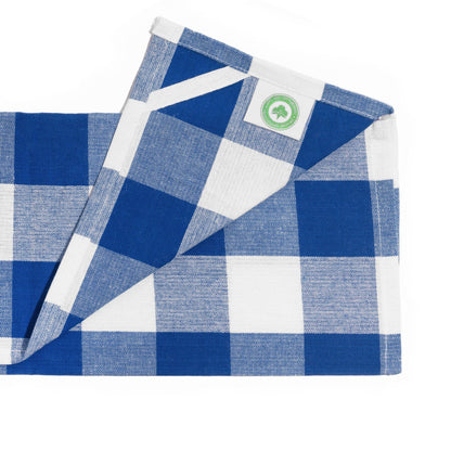 Close-up of a navy-and-white plaid kitchen towel showing its hanging loop.