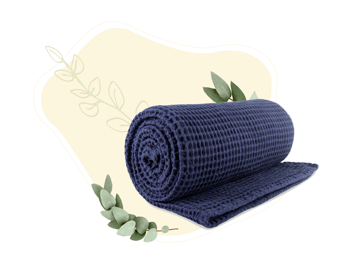 Blue cotton waffle weave throw rolled and partly unrolled