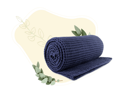Blue cotton waffle weave throw rolled and partly unrolled