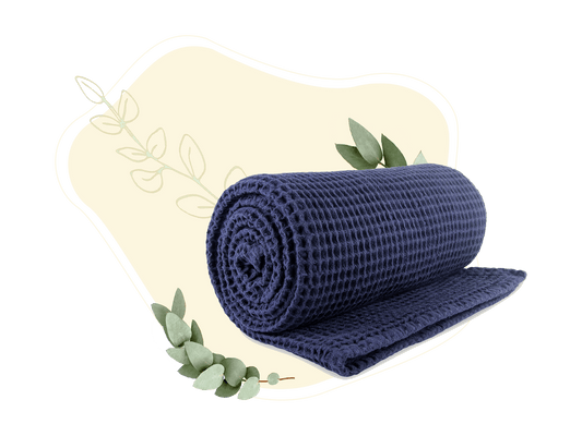 Blue cotton waffle weave throw rolled and partly unrolled