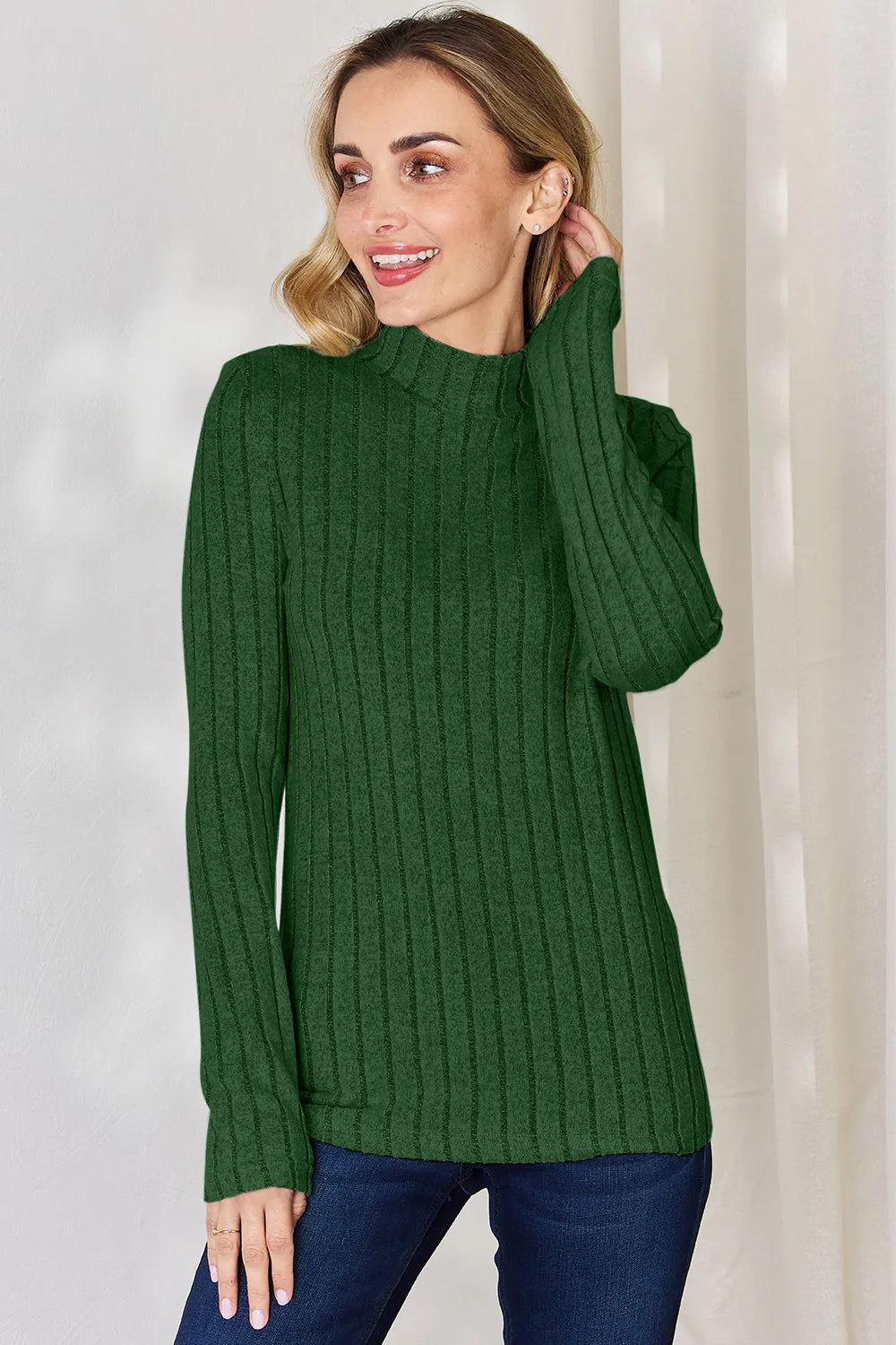 Green ribbed mock-neck long-sleeve top, product view; one top included, jeans and accessories excluded