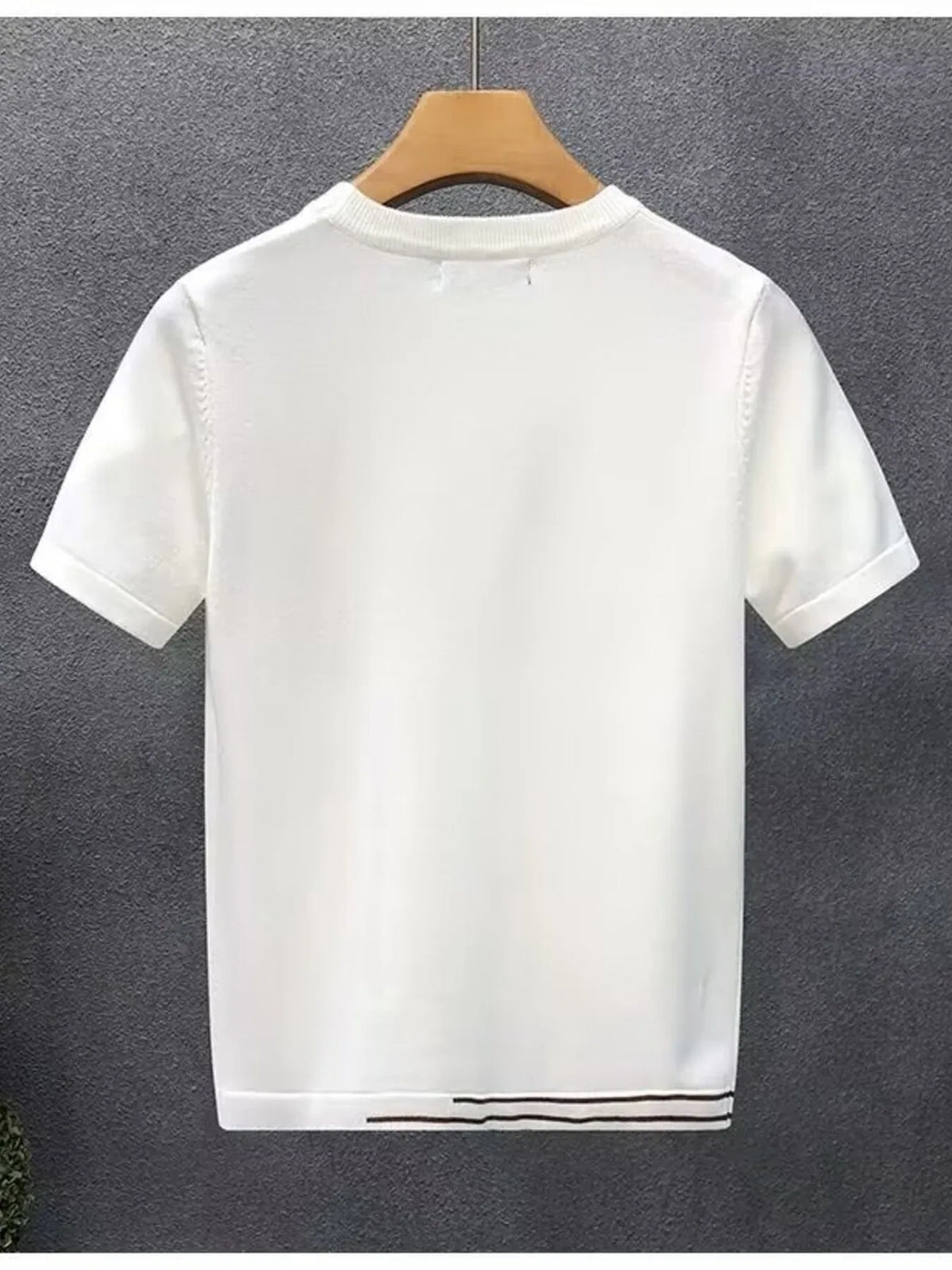 White contrast-trim T-shirt on a hanger, back view.