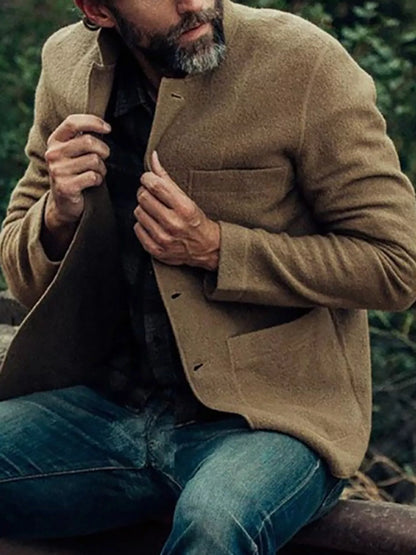 Khaki men's textured button-up jacket shown seated, with front buttons and patch pockets; other clothing is not included.