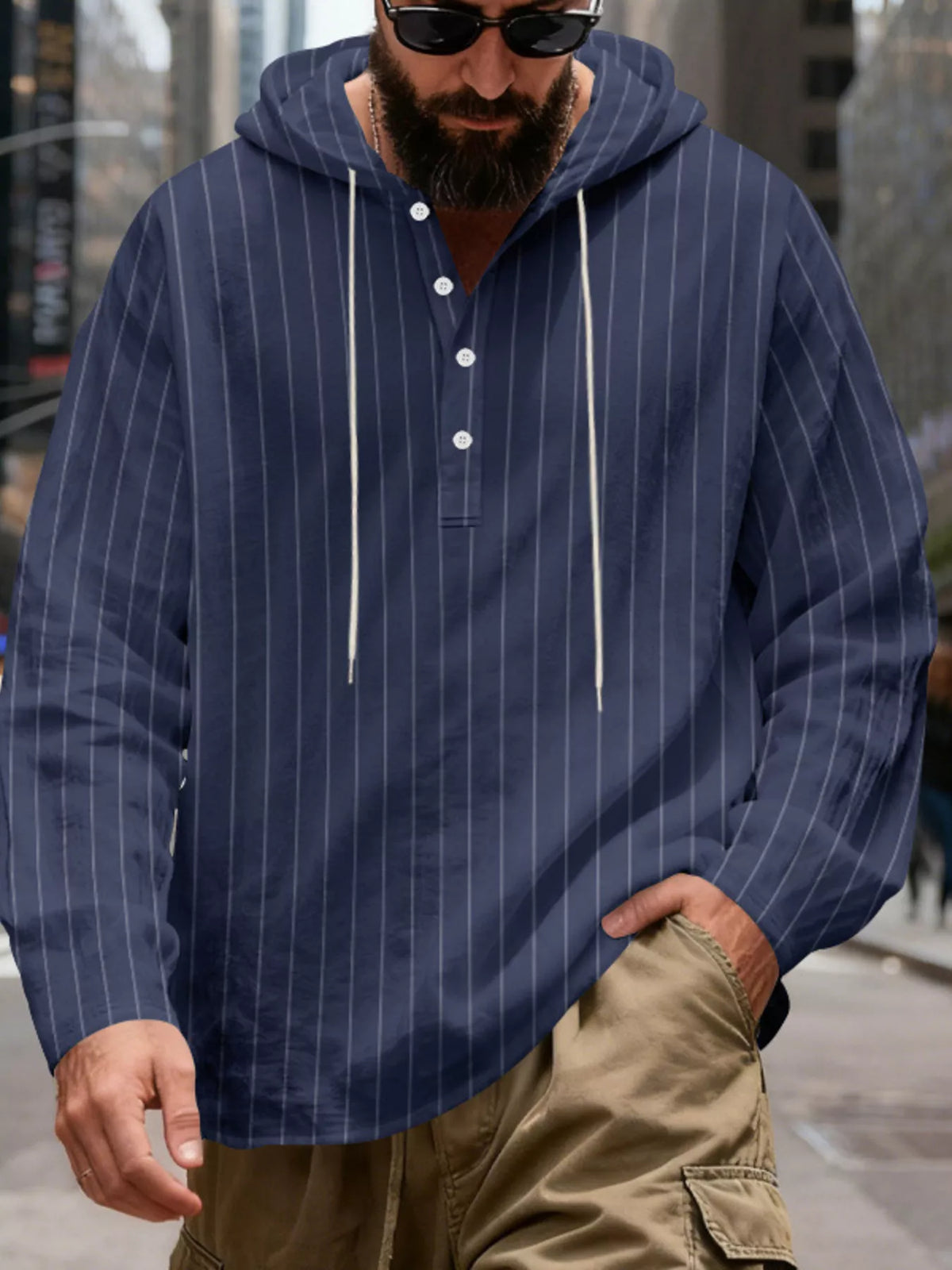 Men's striped Henley hoodie in Navy Blue — front view showing the hood and buttoned neckline; trousers and accessories are styling only.