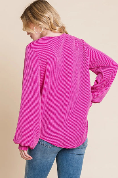 Back view of the fuchsia ribbed top and curved hem