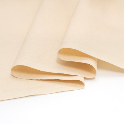 Natural cotton canvas fabric showing folded edge and thickness