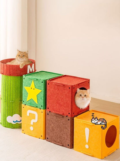 Several felt cubes and barrel-shaped cat house arranged together