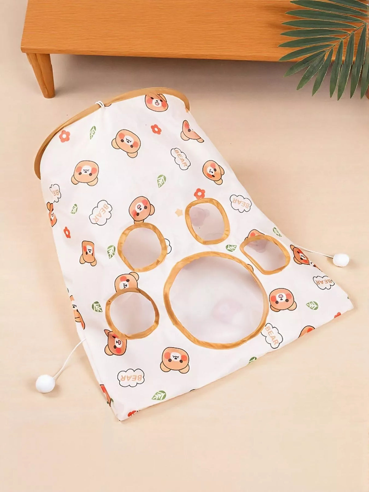 Bear Pattern white collapsible cat tunnel folded flat with orange-trimmed openings