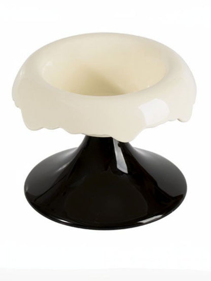 White-and-black elevated ceramic pet bowl shown empty.