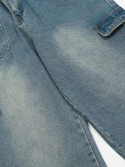 Close-up of the faded upper-leg denim and inner seam on the cargo jeans.