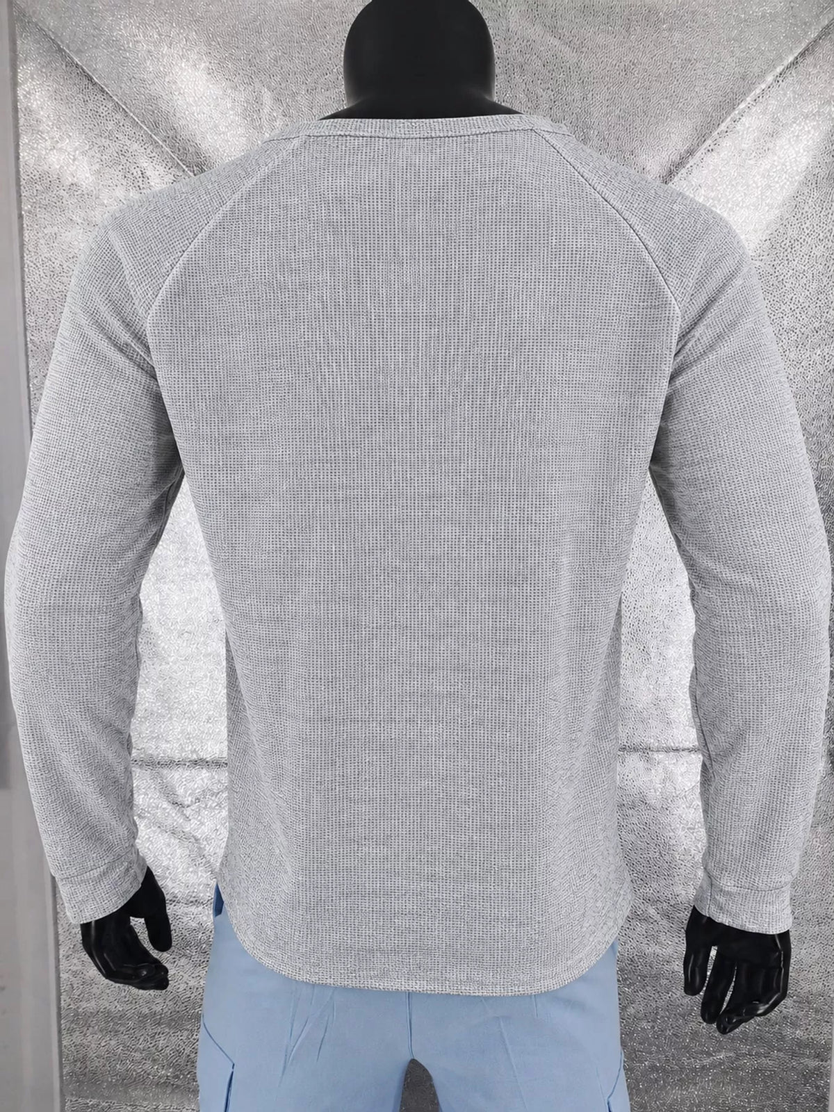 Light gray men’s waffle-knit Henley on a mannequin, back view.