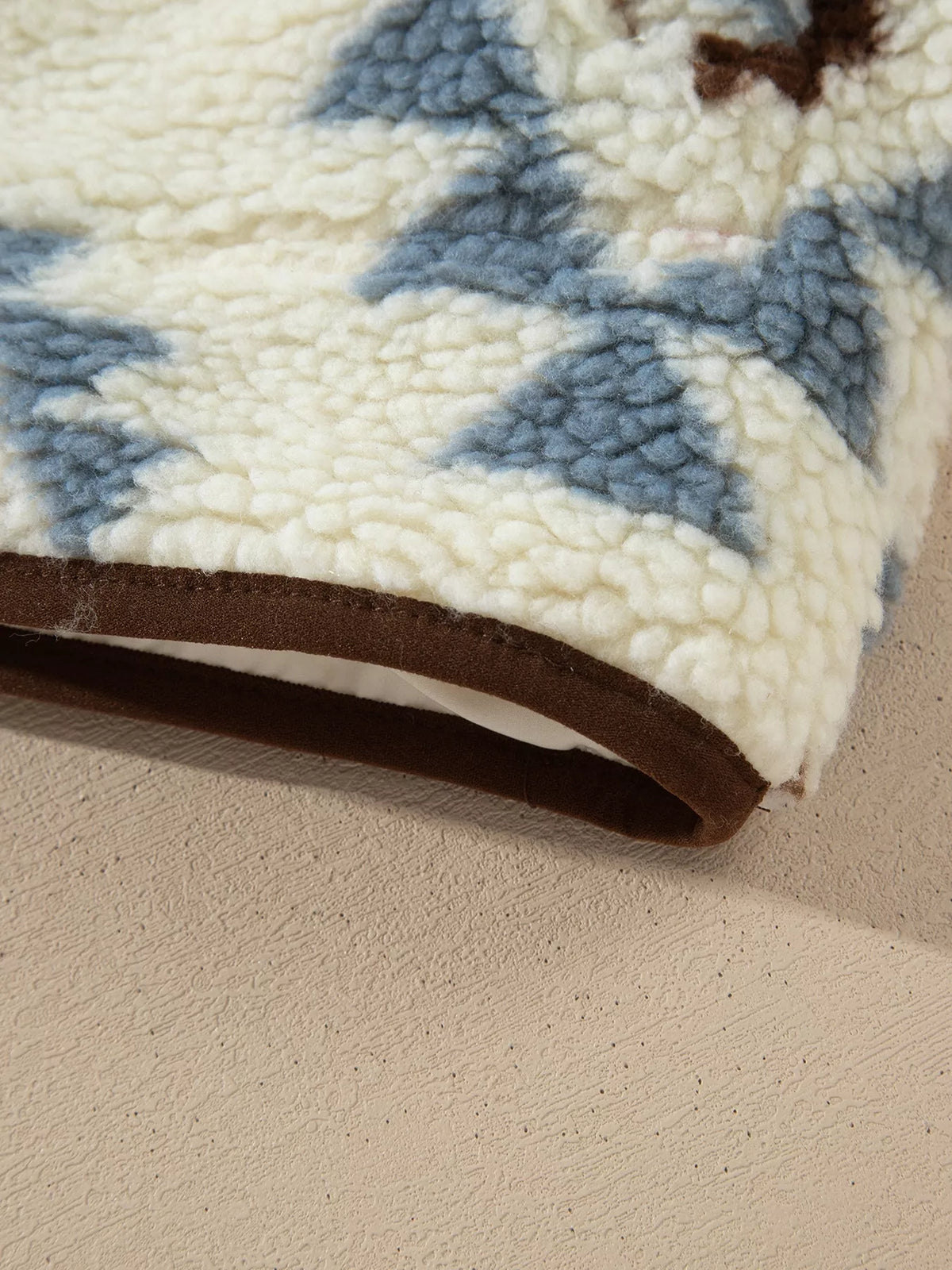 Close-up of the brown-bound sweatshirt hem.