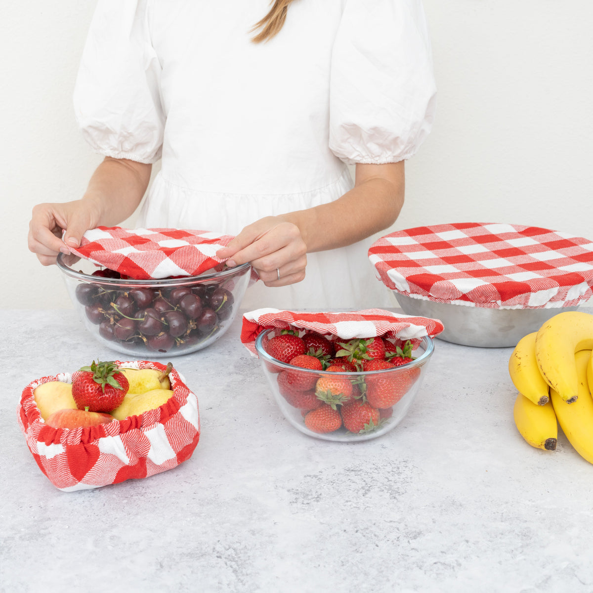 Red and white checked covers used over serving bowls
