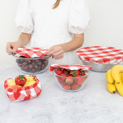 Red and white checked covers used over serving bowls