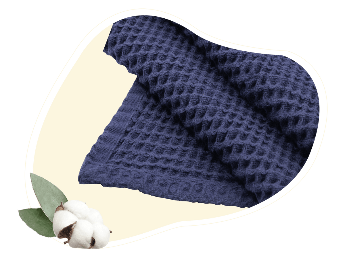 Close-up of a blue cotton throw showing its waffle texture
