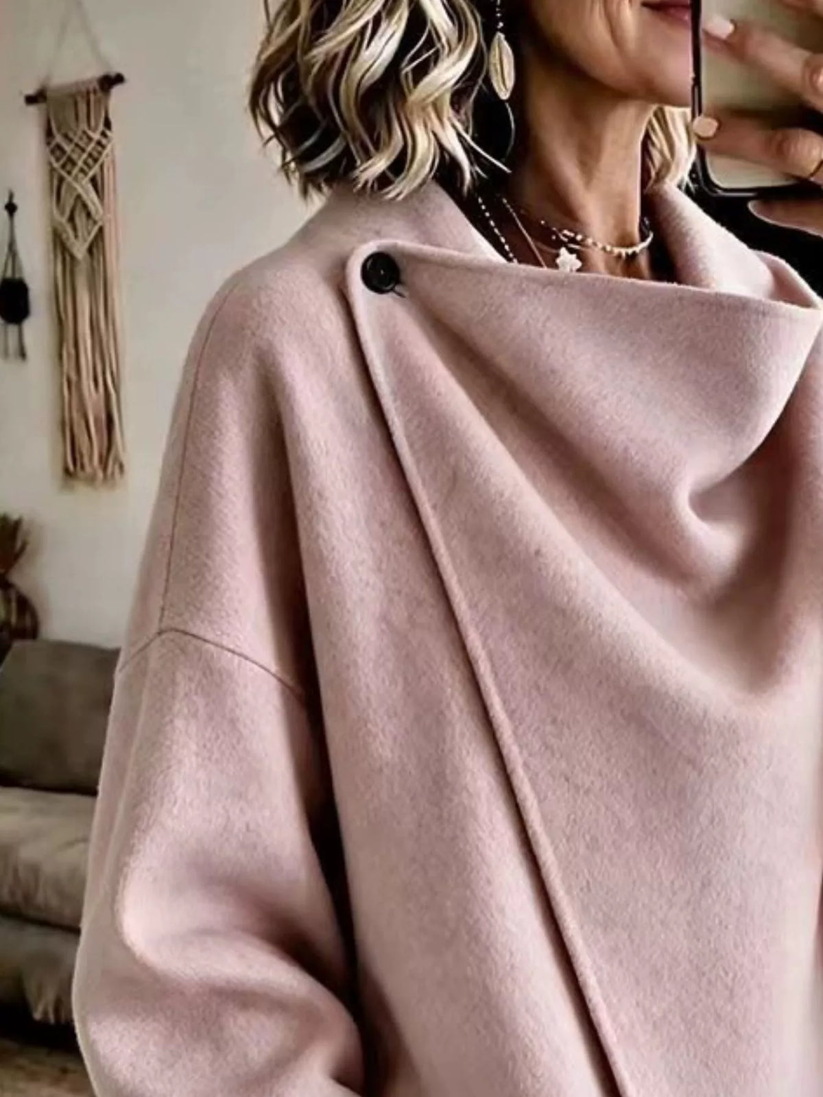 Pink asymmetric cowl-neck cape, close-up of the draped neckline and button detail