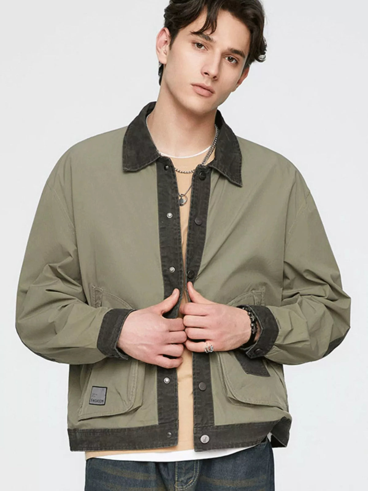 Men's olive green snap-front jacket with dark contrast collar and cuffs