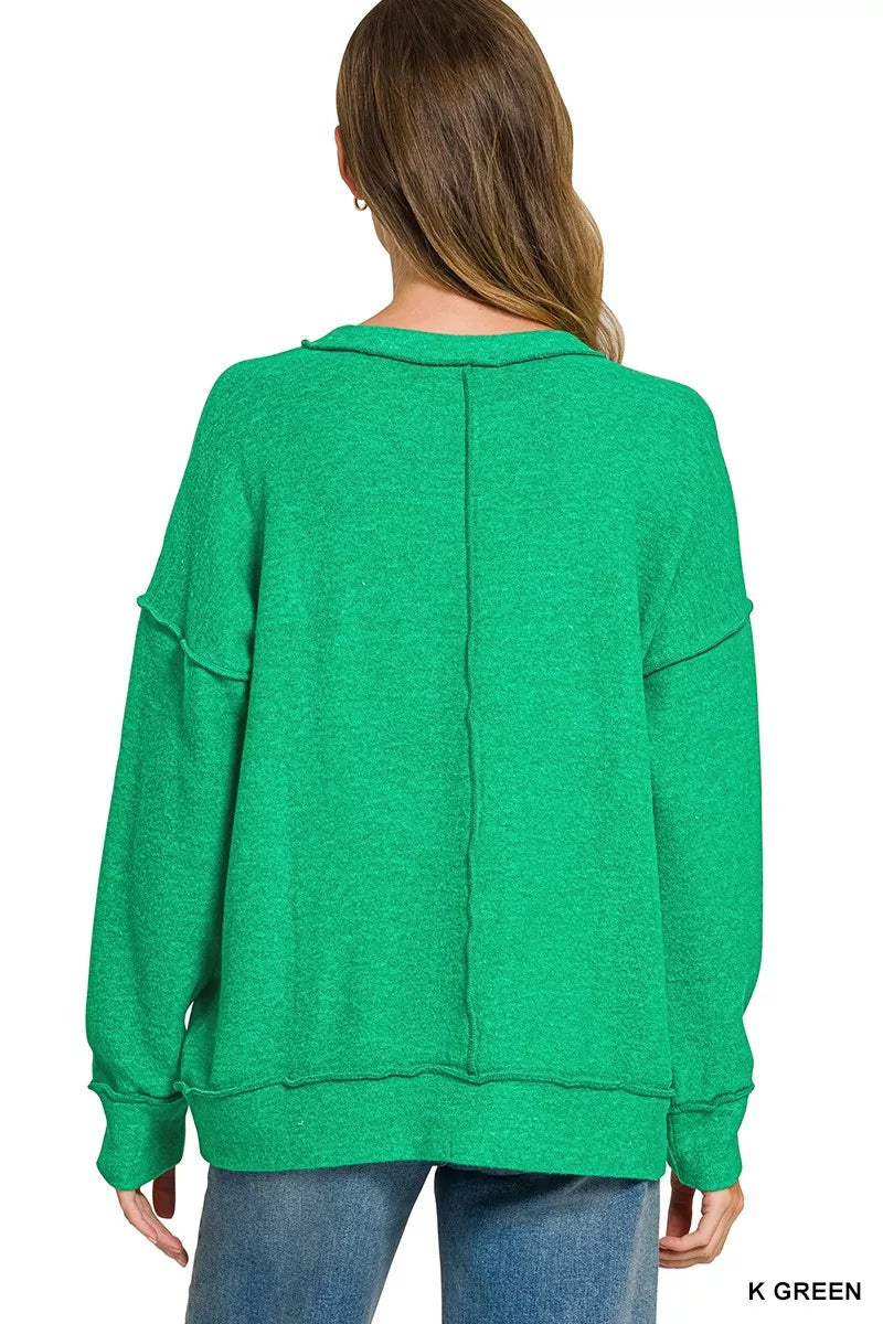 Back of the green Zenana sweater with a center seam and dropped shoulders; jeans are not included.