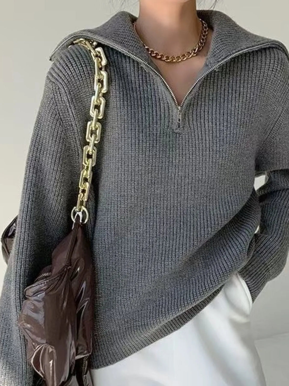 Half-zip long-sleeve ribbed sweater with a high collar.