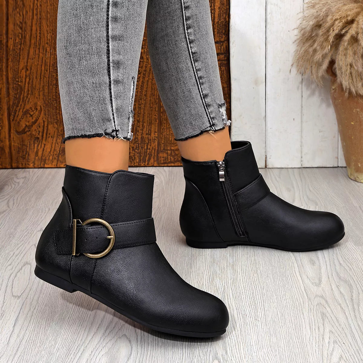 Black ankle boots showing heel and side profiles