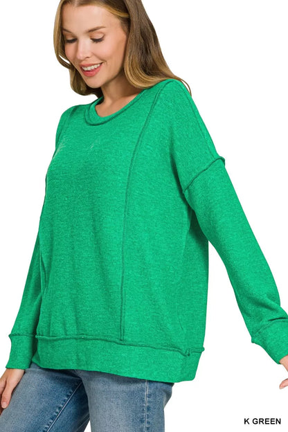 Angled front view of the green Zenana sweater, showing its relaxed fit and long sleeves.