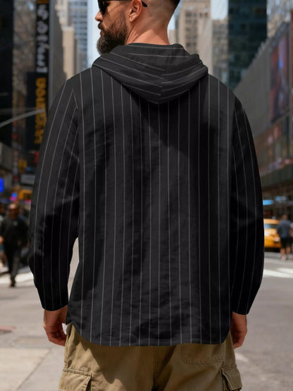 Men's striped Henley hoodie in Black — back view showing the hood and vertical stripe pattern; trousers and accessories are styling only.