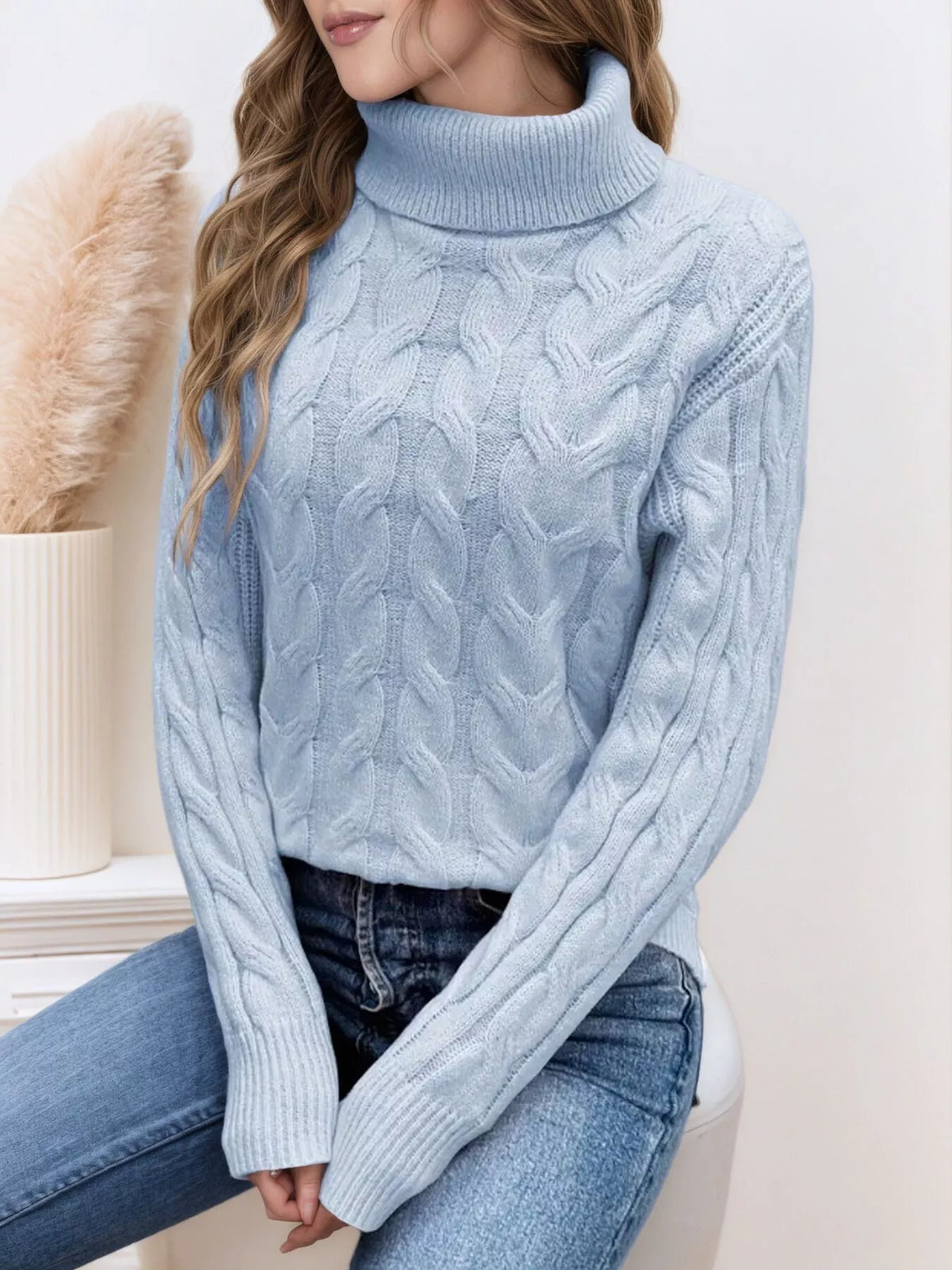 Cable-knit turtleneck sweater with long sleeves.