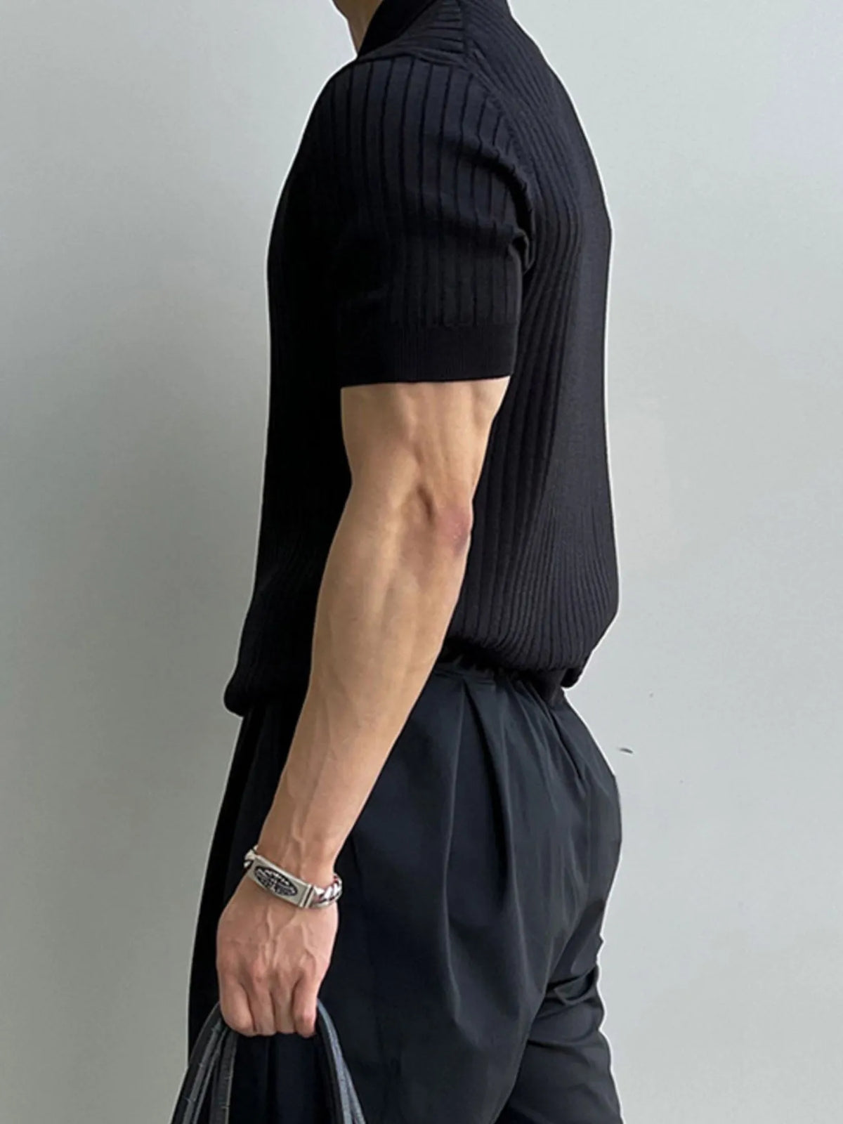 Men's Black ribbed knit polo, side view; styling accessories not included